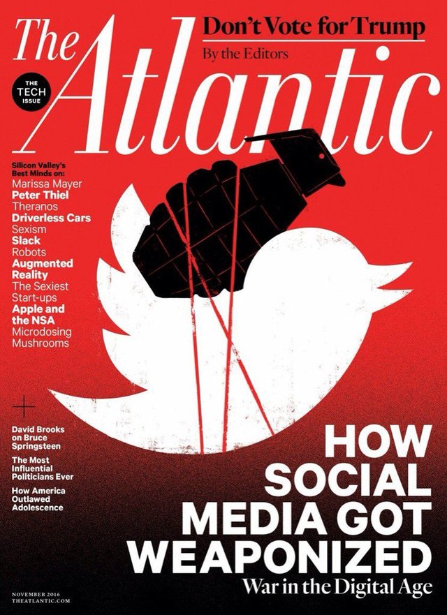 Cover of The Atlantic's November 2016 “Tech Issue,” showing a black clenched fist gripping a lit grenade shaped like a bird's head, with blood-red strings trailing down over a white Twitter-bird silhouette on a red field, beneath the cover line “How Social Media Got Weaponized: War in the Digital Age”