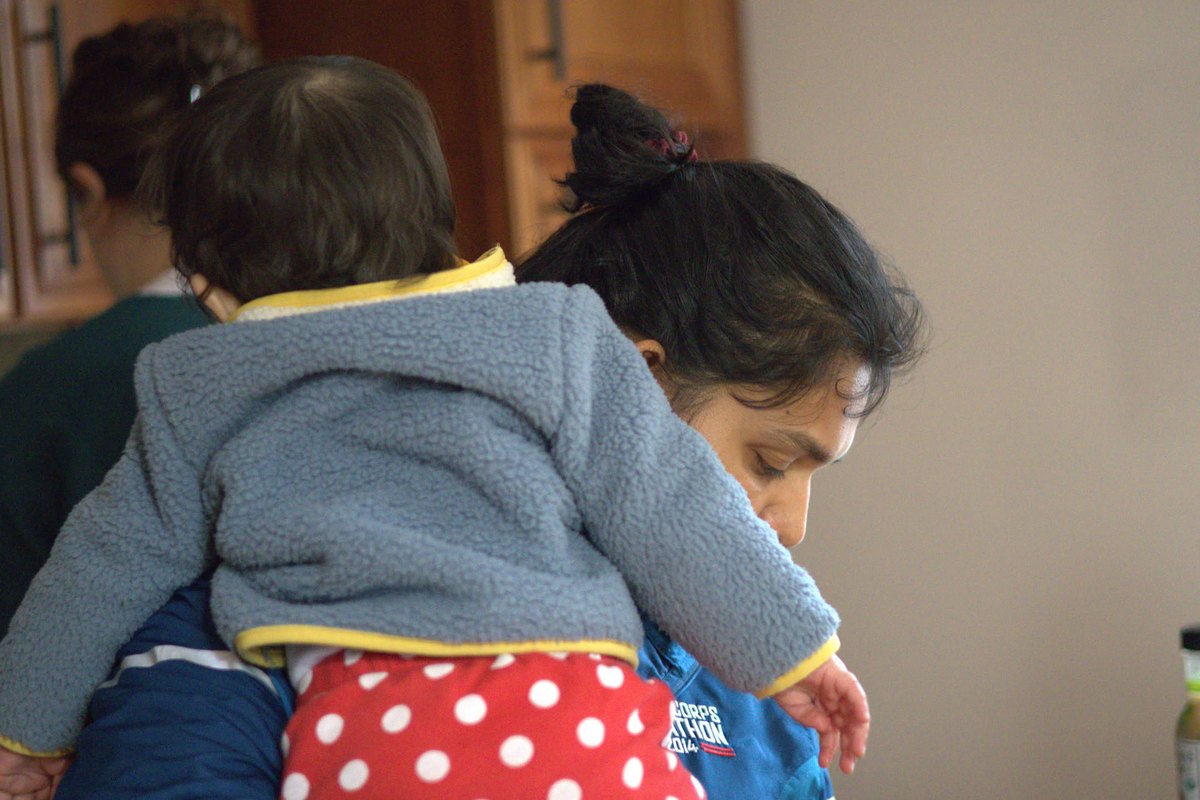 Anubhuti holding our daughter at home