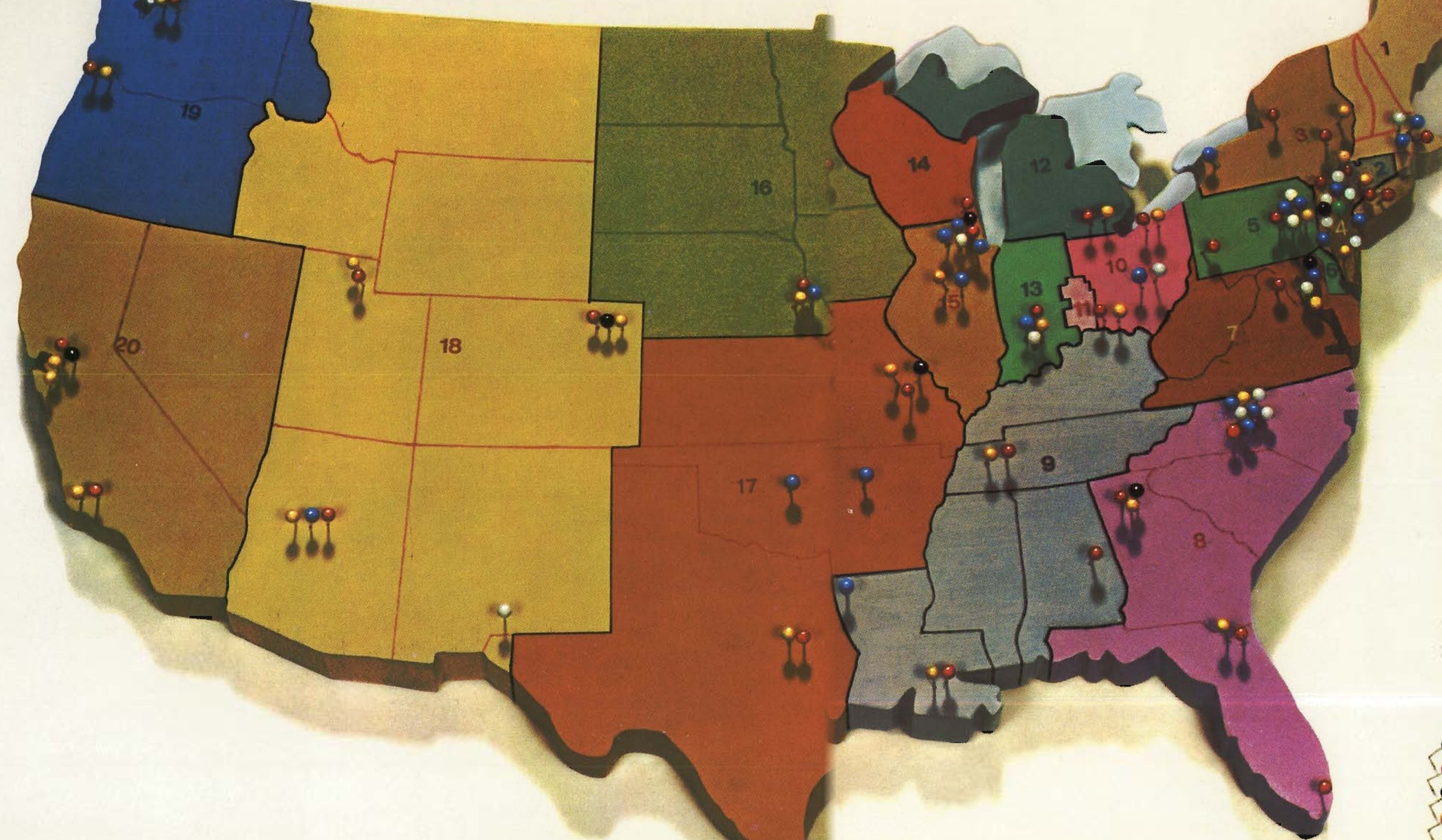 Painted relief map of the United States from AT&T's 1968 annual report, the Bell operating-company territories in mustard, green, orange, violet and grey, each numbered, studded with colored map pins
