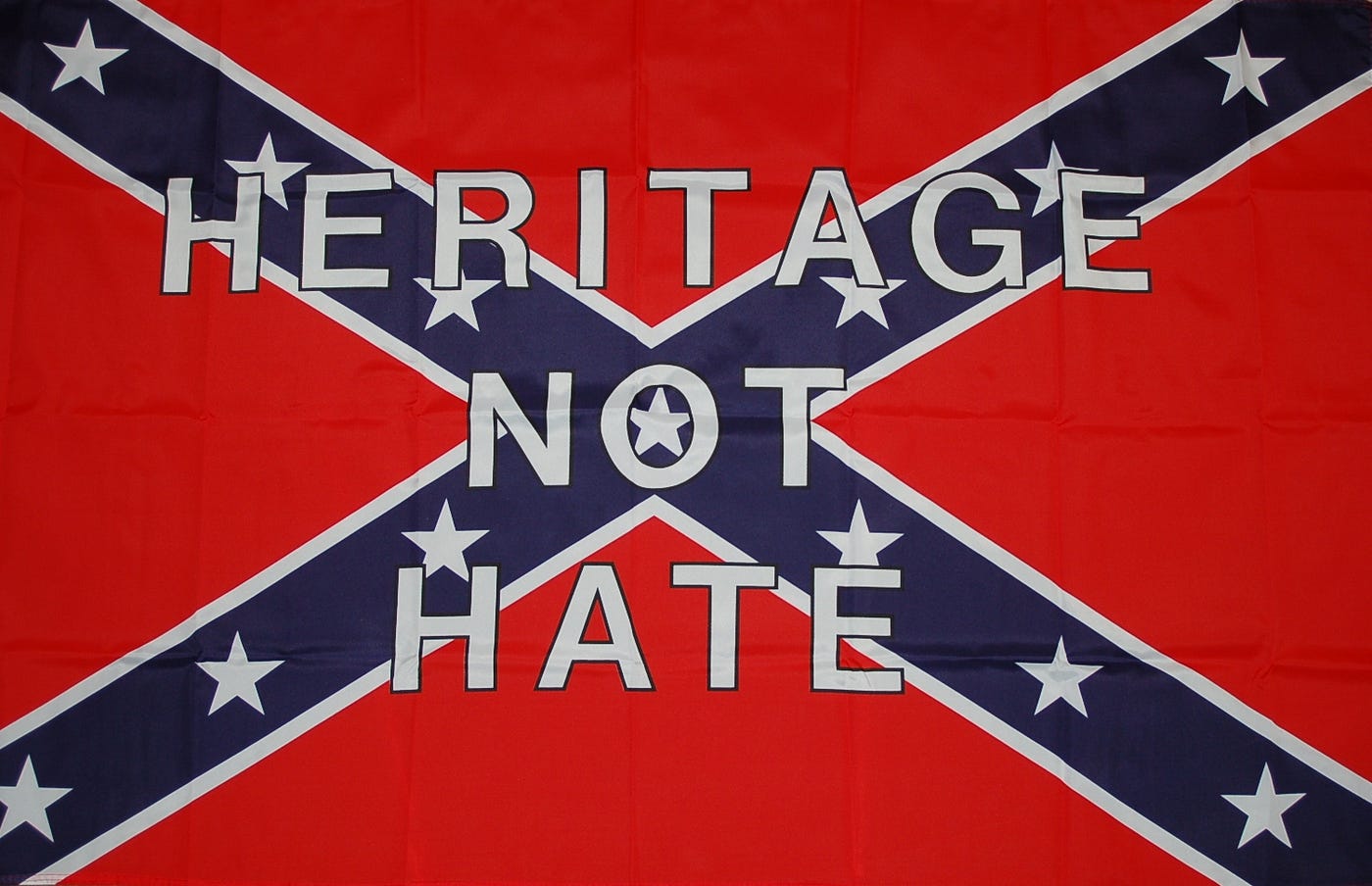 A Confederate battle flag printed with the words HERITAGE NOT HATE.